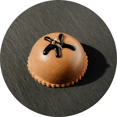 A round milk chocolate praline dome dessert from Preligen Artisan Bakery.