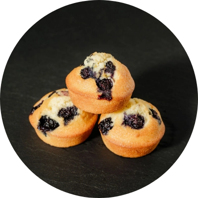 Three lemon blueberry mini pound cakes from a San Jose bakery stacked on a dark surface.